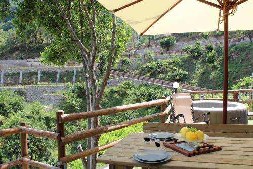 a wooden table with a bowl of fruit on a deck at TENUTA BOSCO-Casa Vacanze in Cetara