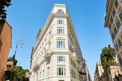 a tall white building on a city street at Sofitel Roma Villa Borghese in Rome