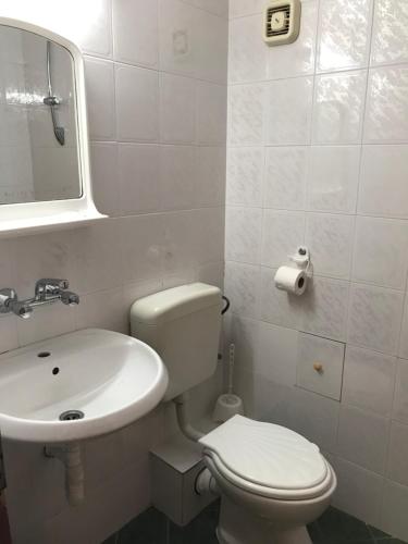 a bathroom with a white toilet and a sink at Hotel Nimfa-Rusalka in Sunny Beach