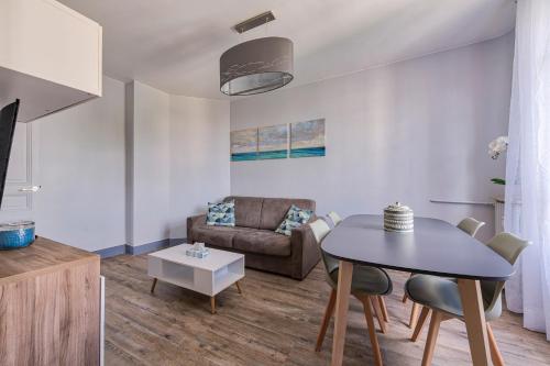 un salon avec une table et un canapé dans l'établissement Confortable 3 pieces, capitale Paris, à Nogent-sur-Marne