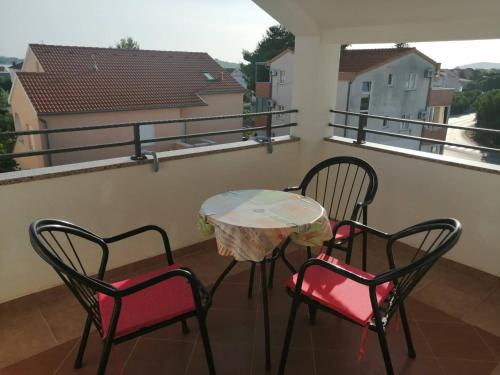 a table and two chairs on a balcony at Apartments Purkovic in Vodice
