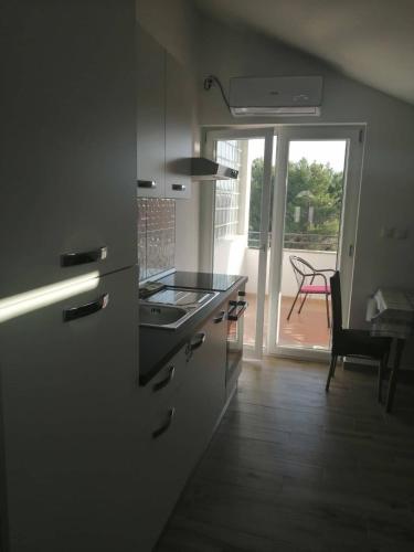 a kitchen with a sink and a stove top oven at Apartments Purkovic in Vodice