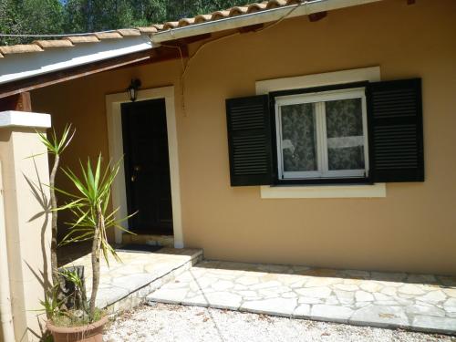 a house with a window and a door at Emely Apartments in Gouvia