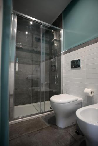 a bathroom with a shower and a toilet and a sink at Barock in Noto