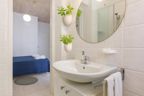 a white bathroom with a sink and a mirror at B&B King in Verona