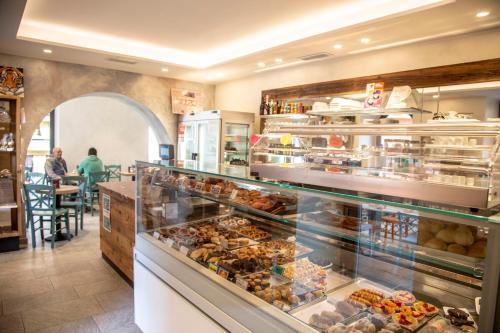 a bakery with a display case filled with lots of pastries at Domus Bellagio in Bellagio