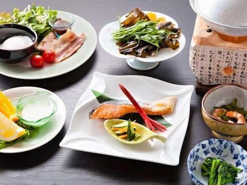 a wooden table with plates of food on it at Nagisatei Taroan in Miyako