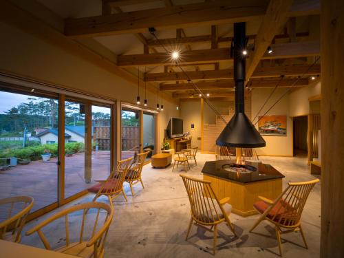 a living room with chairs and a stove at Nagisatei Taroan in Miyako