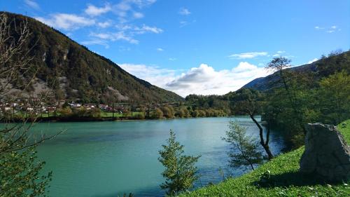 a view of a river with mountains in the background at Apartma MAELL 1 in Most na Soči