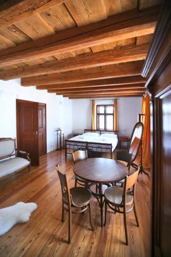 a room with a table and chairs and a bed at Royal Pension in Olomouc