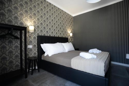 a bedroom with a bed with two pillows on it at Barock in Noto