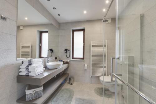 a bathroom with a sink and a toilet and a shower at Luxury Apartments PORTO, free parking in Portorož
