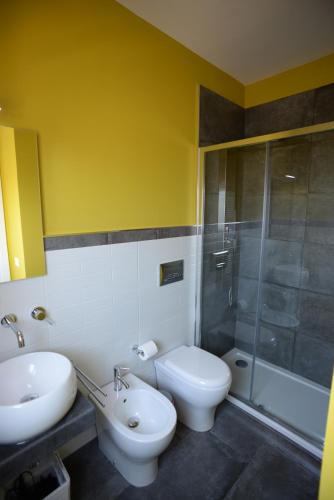 a bathroom with a sink and a toilet and a shower at Barock in Noto