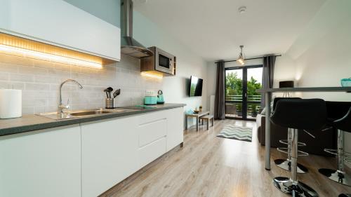a kitchen with a sink and a counter top at Triventi Mountain Residence, Sun & Snow in Karpacz