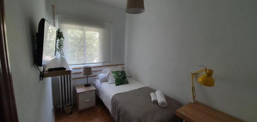 Ένα ή περισσότερα κρεβάτια σε δωμάτιο στο Real Beds Madrid