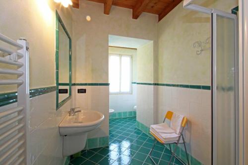 a bathroom with a sink and a toilet and a shower at Cascina Le Preseglie in Desenzano del Garda