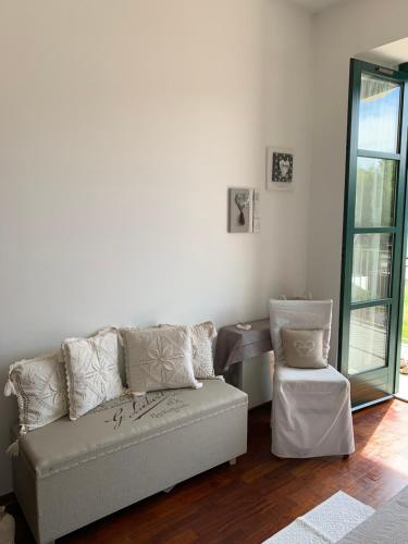 a living room with a couch and a chair at Campione Splendid View by Gardadomusmea in Campione del Garda