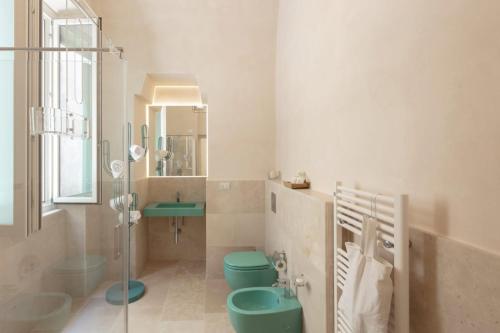 a bathroom with two toilets and a sink and a shower at Dimore Marinare in Trani