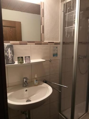a bathroom with a sink and a shower at Zum Kirchenbauer in Oberammergau