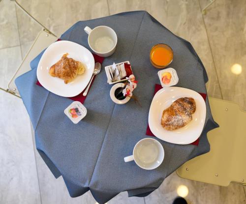 a table with two plates of food and cups of coffee at Ville Vesuviane in San Giorgio a Cremano