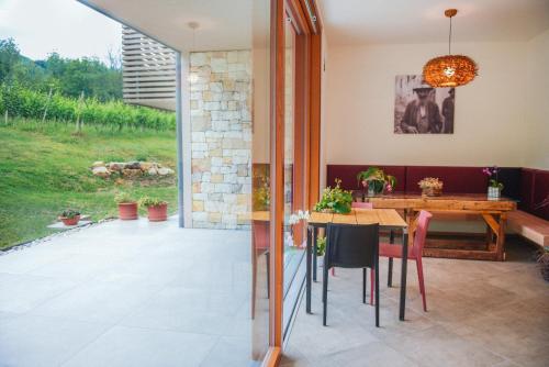 a kitchen and dining room with a table and chairs at Agritur Verderame in Trento
