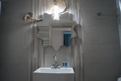 a bathroom with a sink and a mirror at Kymata in Mikonos