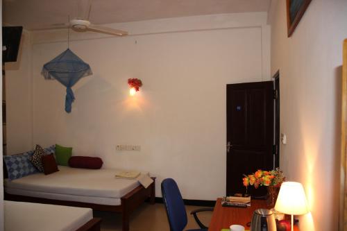 a living room with a couch and a table at Miheen Hotel & Resort - Anuradhapura in Mihintale
