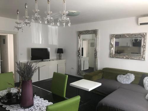 a living room with a couch and a mirror at Casa di Lavanda in Hvar