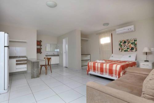 a living room with a bed and a kitchen at Porto Seguro Flat in Pecém