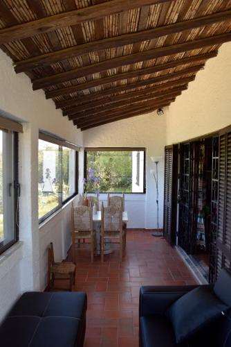 a living room with a table and chairs and a ceiling at Algarve booking Casa Alfarrobeira Benagil Caves private parking airco heated private pool - AL in Carvoeiro