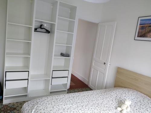 a bedroom with white shelves and a bed at imperatrice 2 in Berck-sur-Mer