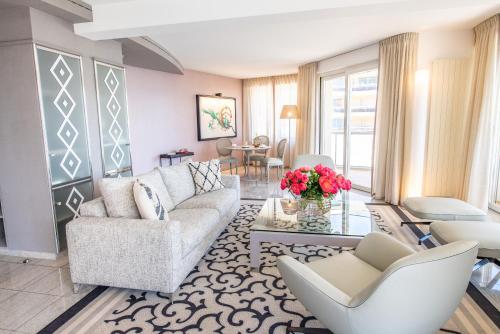 a living room with a couch and chairs and a table at Hotel Eden Roc - The Leading Hotels of the World in Ascona
