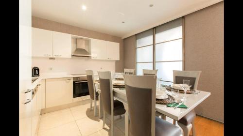 a kitchen and dining room with a table and chairs at CTS Elysium Residence Taksim in Istanbul