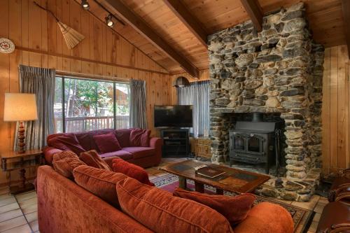 a living room with couches and a stone fireplace at 69 Bordentown West in Wawona