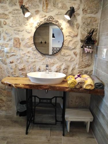 a bathroom with a sink and a mirror at Studio apartmani Šverko in Punat