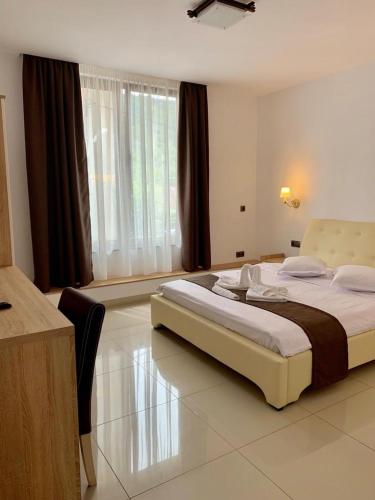 a bedroom with a large bed in a room at Pensiunea OK in Vişeu de Sus