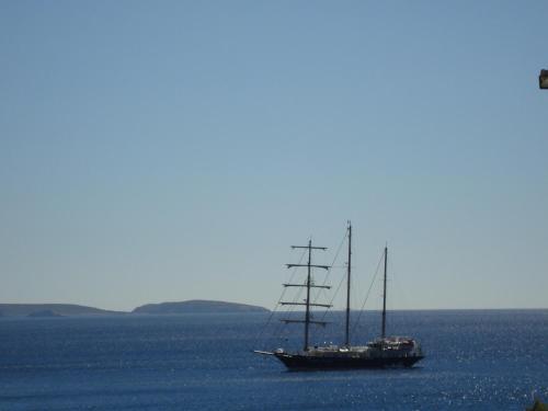 a sail boat in the ocean on the water at Stampalia Luxury Studios in Astypalaia Town