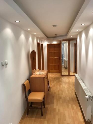 a room with a desk and a chair and a door at Tri šešira Ljubovija in Ljubovija