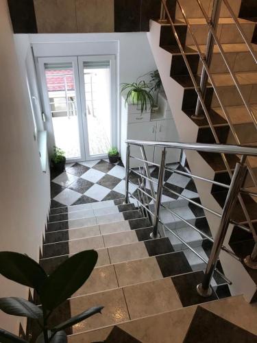 a staircase with a black and white checkered floor at Tri šešira Ljubovija in Ljubovija