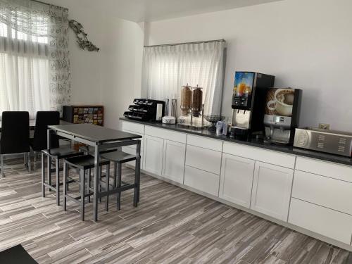 a kitchen with a table and chairs and a counter at Days Inn by Wyndham Waynesville NC in Waynesville
