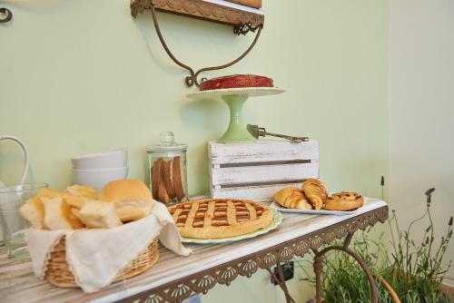 a table with bread and pastries on it at Agriturismo Casastella in Ceriale