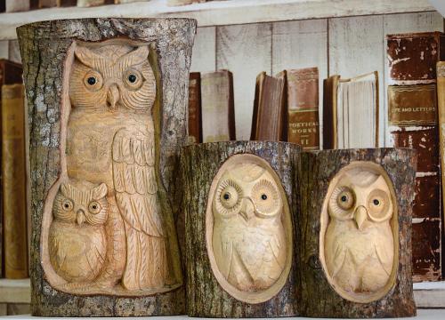 four wooden owls are sitting on a shelf at The Winter Garden Suites in Blackpool