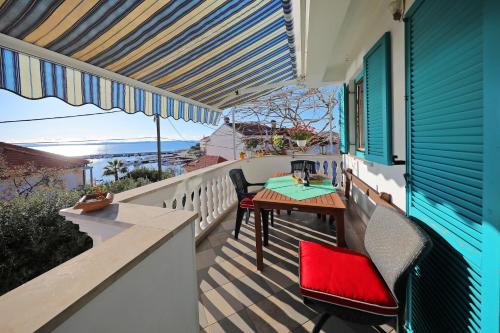 a patio with a table and chairs on a balcony at Apartment Tea with Sea View in Petrcane