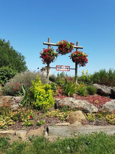 a cross with flowers on it in a garden at SW Cosy Apart - Chambly Persan Roissy in Persan