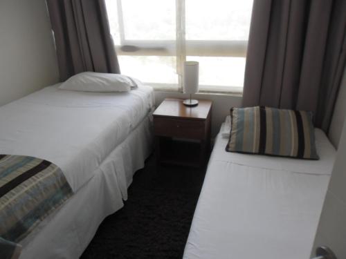 Cama o camas de una habitación en Rentaparts Sucursal Manquehue