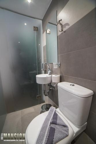 a bathroom with a toilet and a sink at Mansion Hotel in Athens