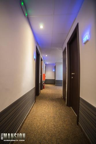 a hallway of an office building with a blue light at Mansion Hotel in Athens