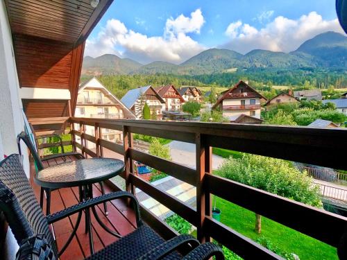 a balcony with chairs and a view of the mountains at Apartments Green Paradise in Bohinj