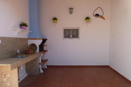 a kitchen with a sink and a counter top at Monte da Cascalheirinha in Santo André