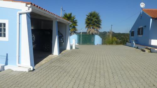 a parking lot of a building with a garage at Monte da Cascalheirinha in Santo André